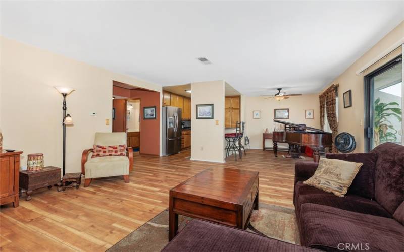 Living room opens to kitchen and family area (piano does not convey)