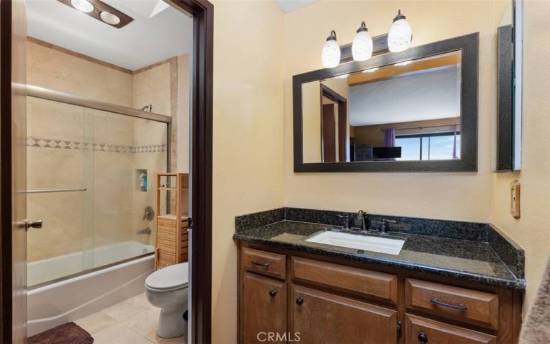 Renovated Primary bathroom, granite counter and travertine floor