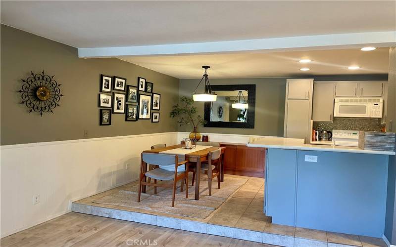 Dining room features custom lighting, wainscoting and room for all your guests