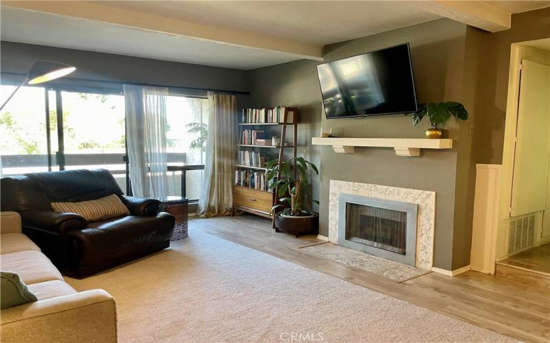 Living room with fireplace and TV bracket accommodates your biggest sectional and opens to scenic deck