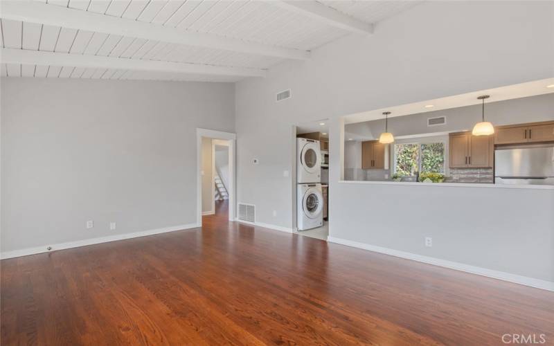 Across the Living Room is the Hallway leading beyond to the 2 bedrooms & bathroom. The pass-through Kitchen is on the right.