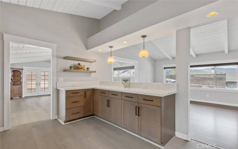 The Island/Counter area of the Kitchen overlooking the Living Room on the right and stepping down to the family room on the left.