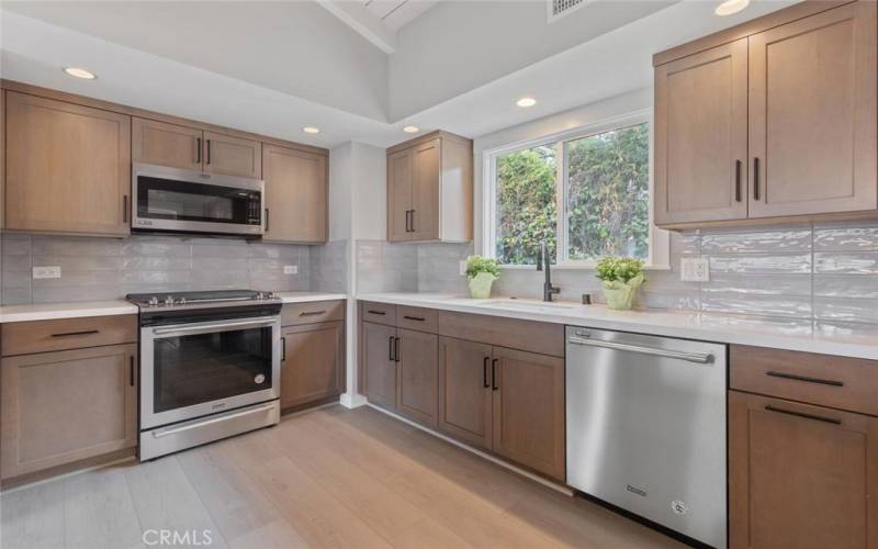 During the Kitchen remodel, the silent-closing drawers & cabinets were added, with a subway tile back splash and white stone-like counter tops.