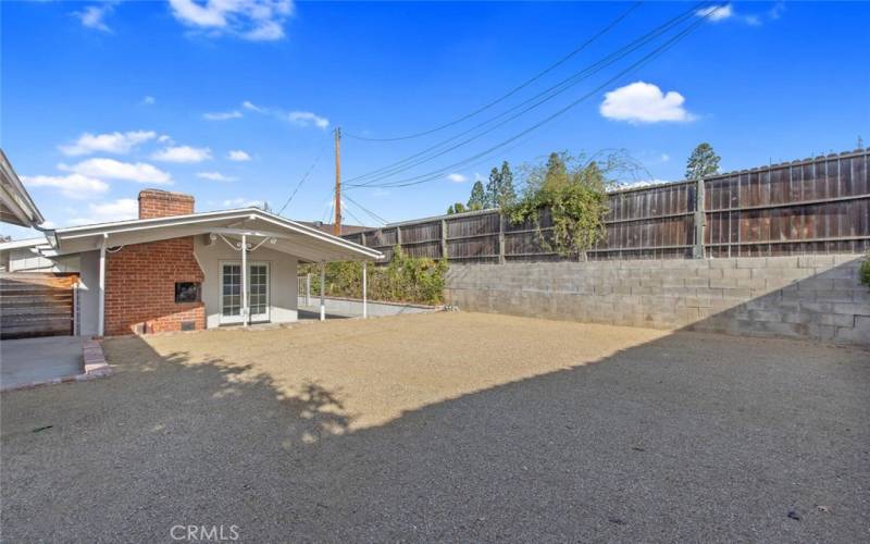 Looking across the DG to the back of the house. Back Yard is very spacious with lots of potential. Veggie garden anyone?