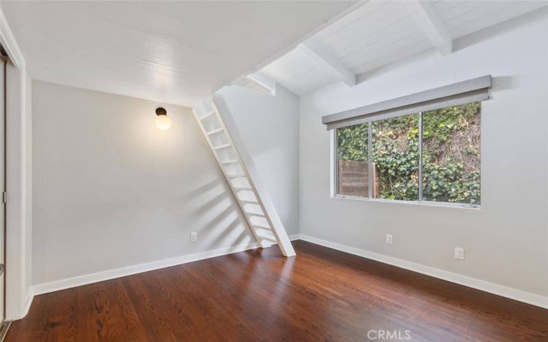 Bedroom #2 with ladder leading to a short loft area.