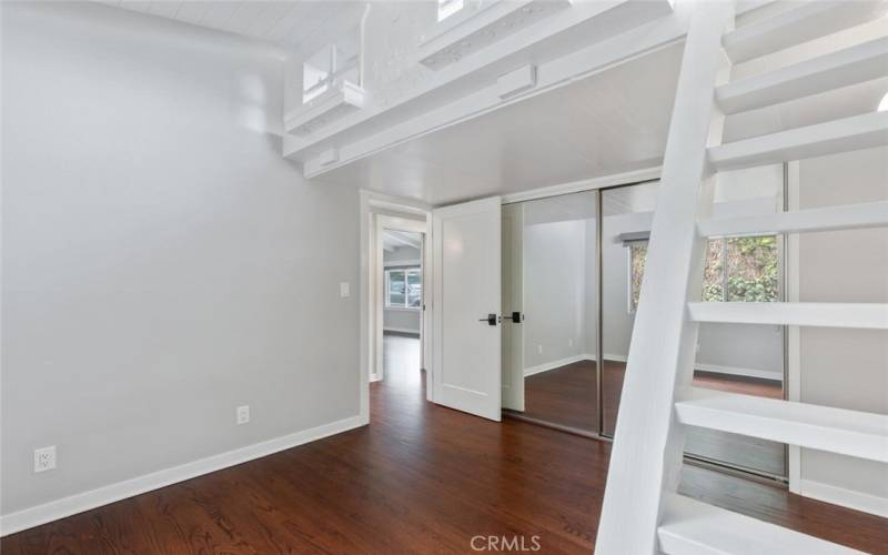 Bedroom #2 with mirrored closets and a short loft area above