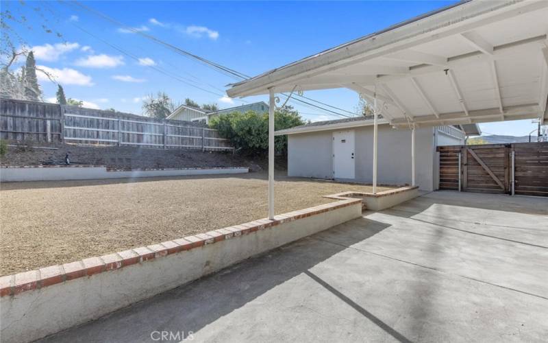 Outside the Family Room is a spacious Back Yard with covered patio, decomposed granite area, and at the far end  is the Detached 2 Car Garage