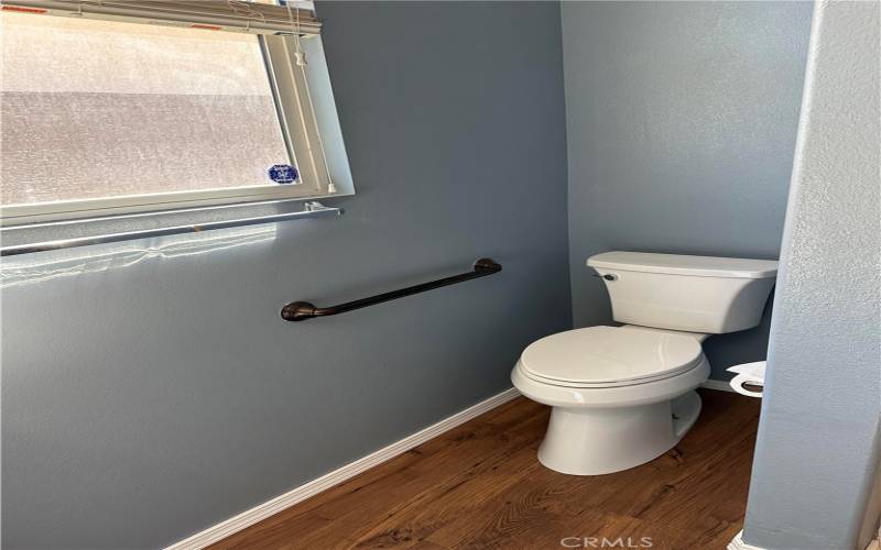 Second bathroom received new waterproof wood laminate! This bathroom has a window that faces the front entry walkway.