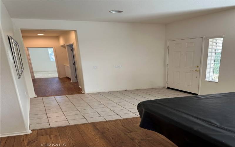 Front entry is white tiled. Hallway to the right just received wood laminate! A gorgeous update!