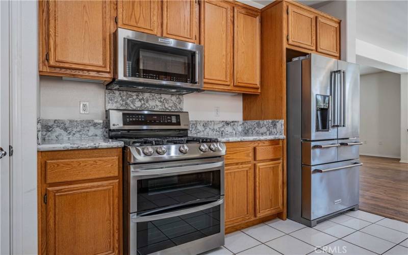 New 5K refrigerator, new stove with gas burners. Microwave above. New quartz countertops.