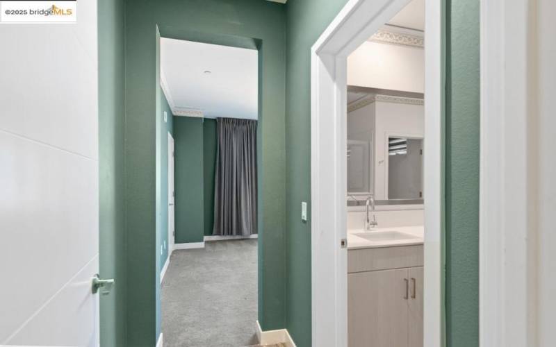 View of primary bedroom from door, to the right is primary bathroom.