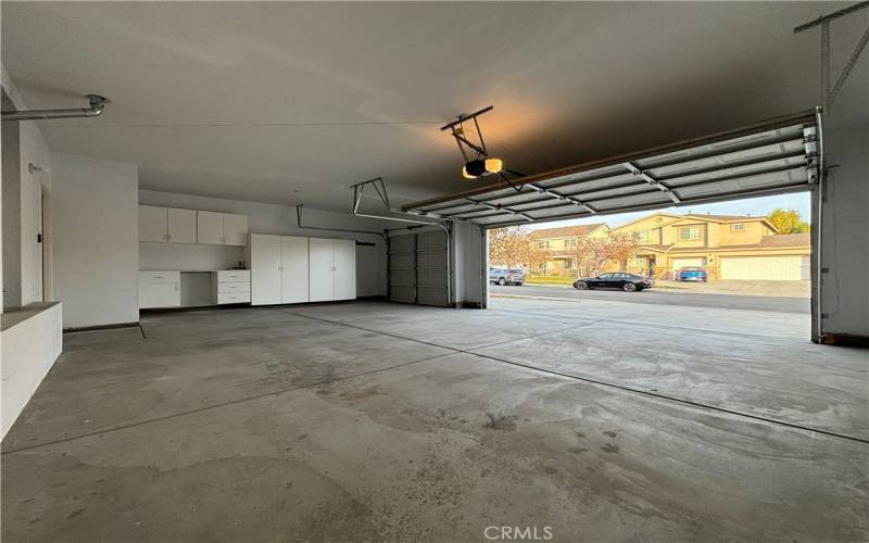 Large 3 car garage with workbench and cabinets