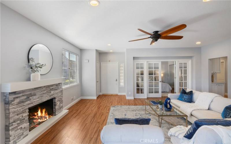 Living area has cozy fireplace and beautiful wood floors