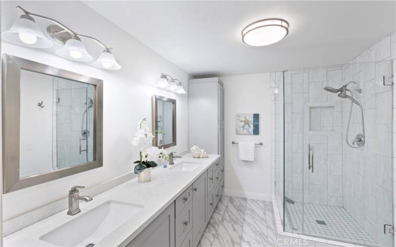 Primary Bathroom has dual sinks, oversize shower and ample storage space