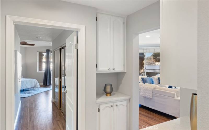 Both sides of hallway have storage cabinets.