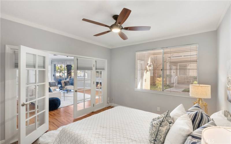 French doors in secondary bedroom have shades that can be pulled down for privacy.