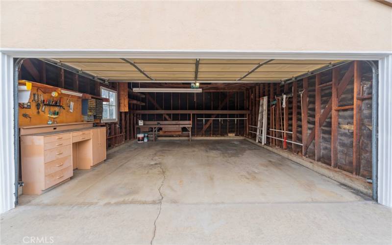 Garage has some cabinets for storage and a roll up door with opener.