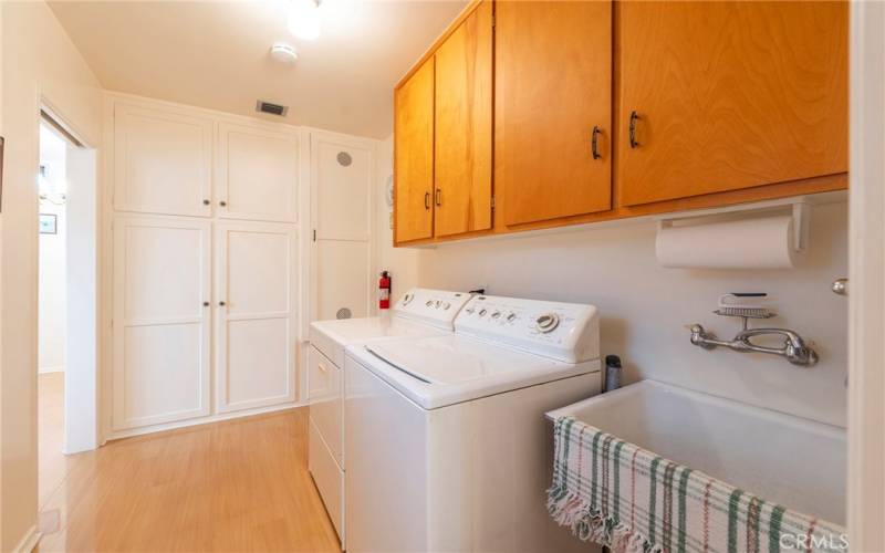 Door on the left leads to the kitchen. You have a back door and utility sink too.