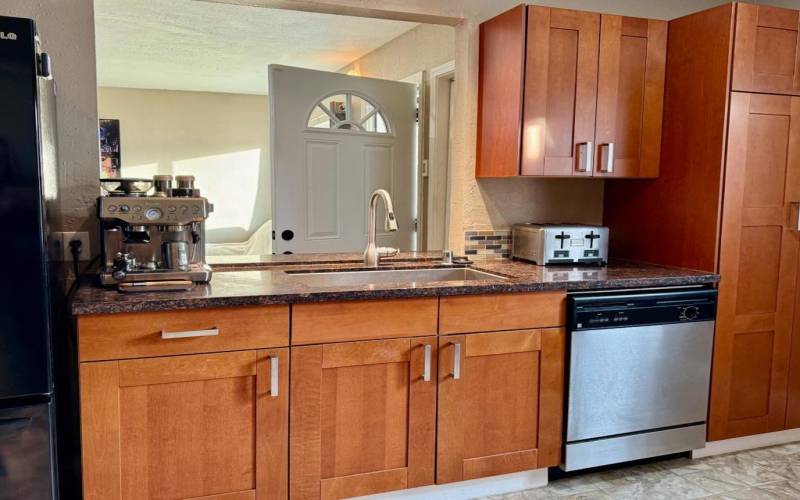 Cook's kitchen cabinets, sink area overlooks living room