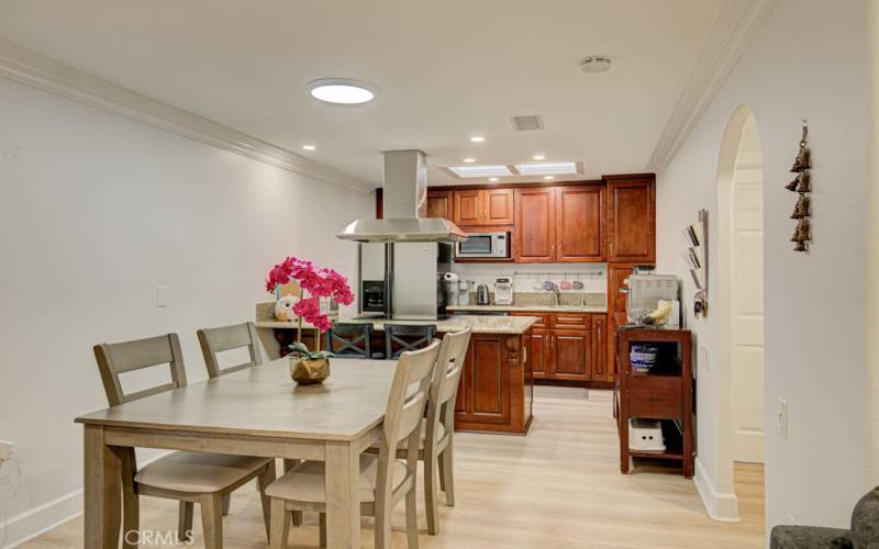 Dining room with kitchen in background. Note the solar tube above the dining table and skylight in the kitchen.