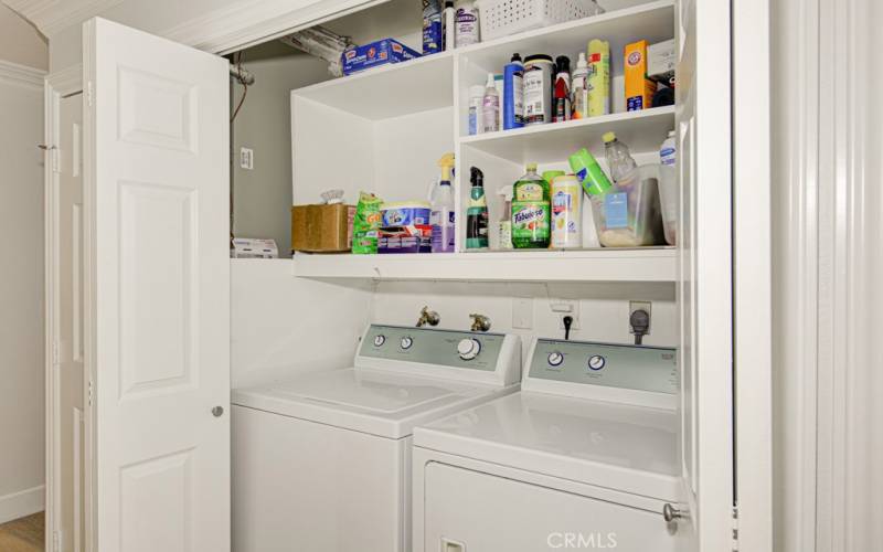 Full-size side-by-side washer-dryer conveniently located in the hall closet.