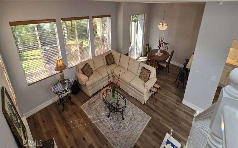 View from grand stairwell of luxury living room abd dining room