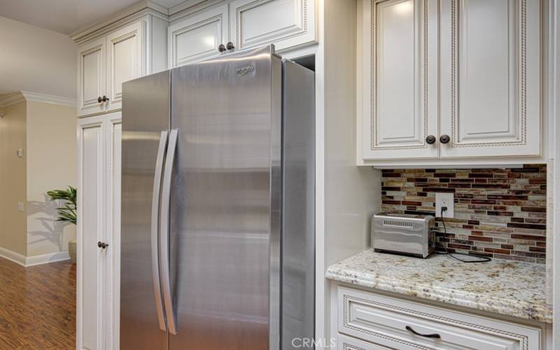 Nice coffee bar next to the refrigerator.