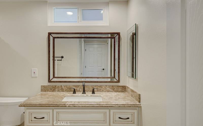 Primary Bathroom has a large vanity with granite countertop.