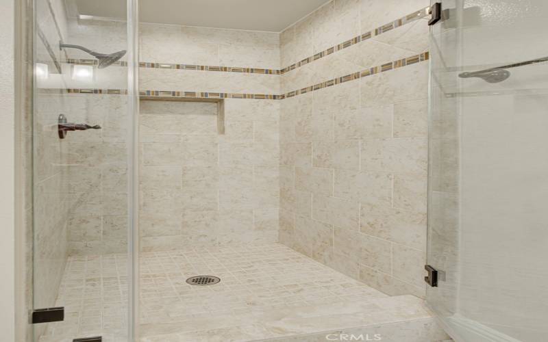 The guest bathroom has a beautiful step in shower..