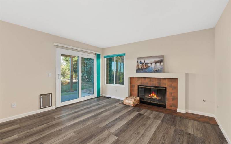 Family room with the inviting fireplace and view of the private backyard.