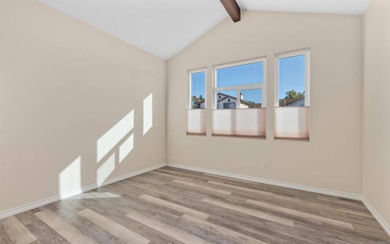 Entertain with ease in the formal living room, enhanced by a vaulted ceiling.