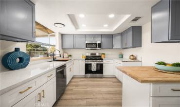 Gorgeous 2 Tone Kitchen with brushed Gold hardware, stainless appliances and, soft close drawers