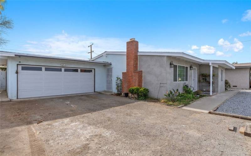 Side view of home with garage and pedestrian door