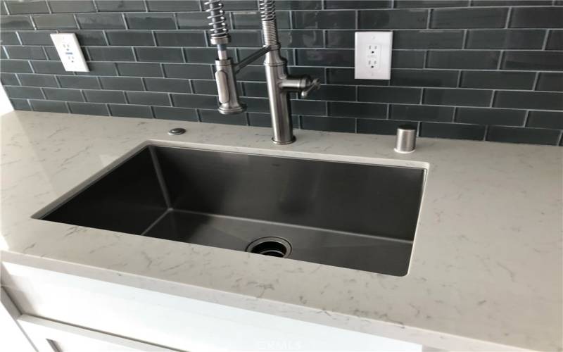 Stainless steel sink with designer backsplash