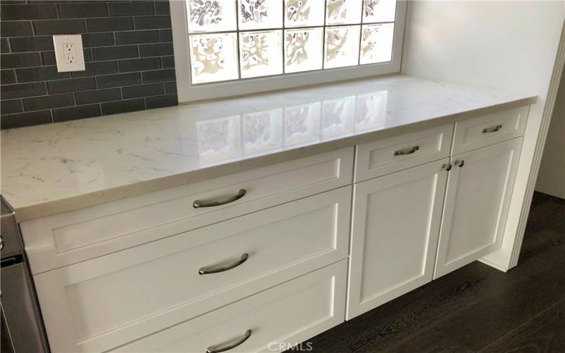 Kitchen has bright privacy windows for natural lighting