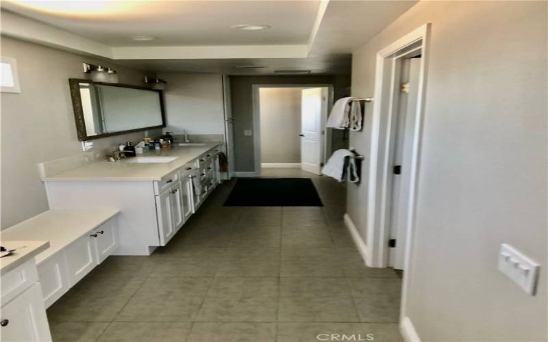 Main bath with walk-in closet, separate shower and tub and dual sinks