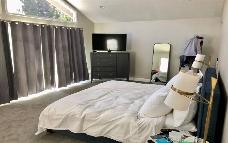 Master bedroom with windows that span the back wall with gorgeous lake views.