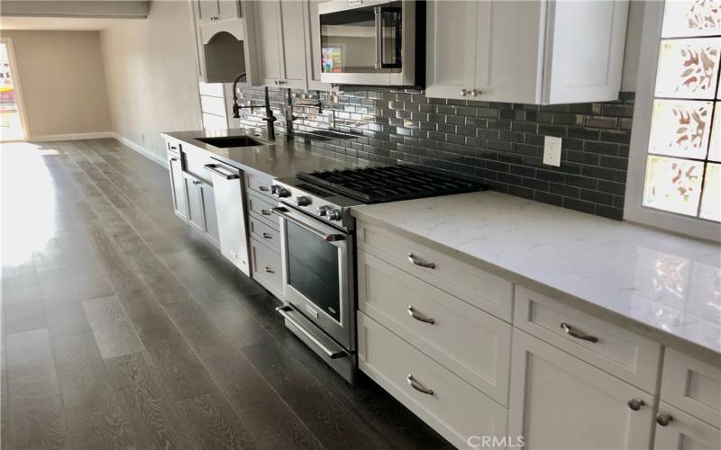 Upgraded kitchen with generous shaker cabinets and quartz countertops