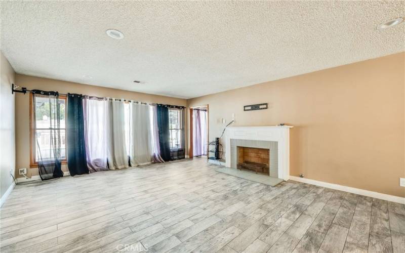 Spacious Step Down Living Room with Fireplace and brackets for your TV