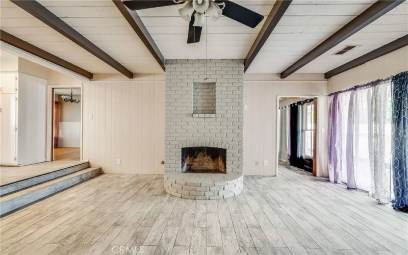 Gorgeous beamed ceiling in the spacious family room with wood burning fireplace