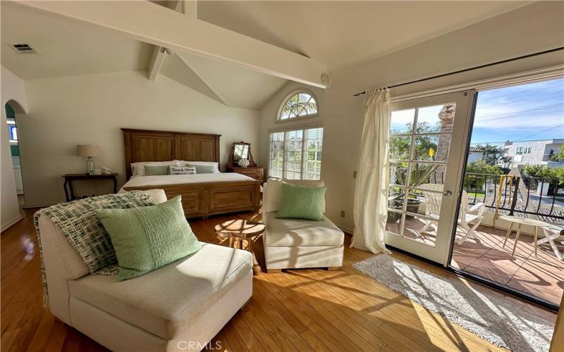 Formal seating area in primary bedroom adjacent to the private balcony