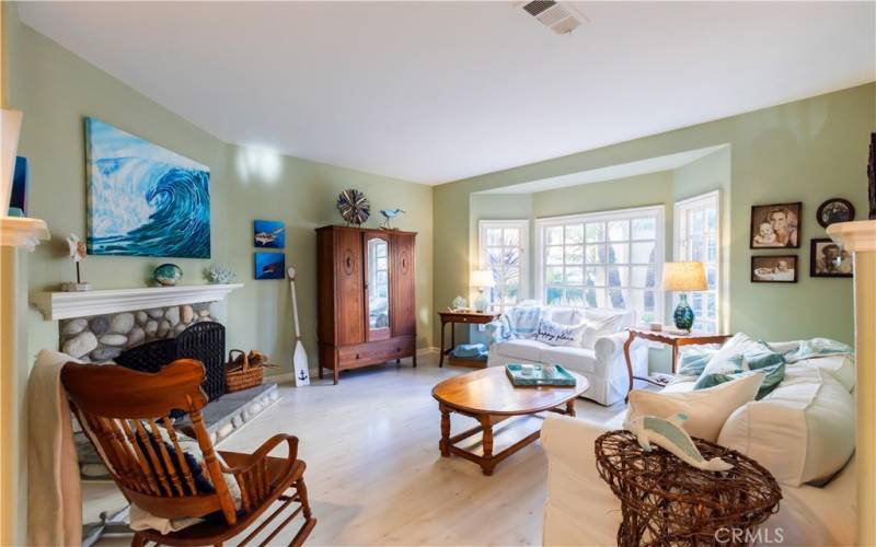 Large bay window in living room that overlooks the private courtyard of complex