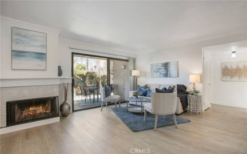 Living room has fireplace. Sliding door leads to the backyard.