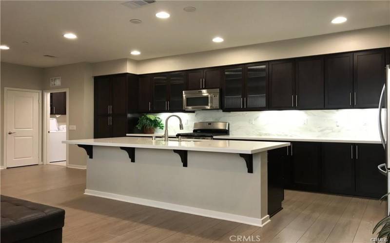 Quartz countertops and matching stainless appliances.