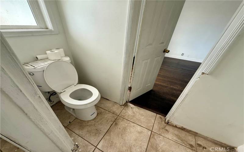 Half bath has direct access to a bedroom.