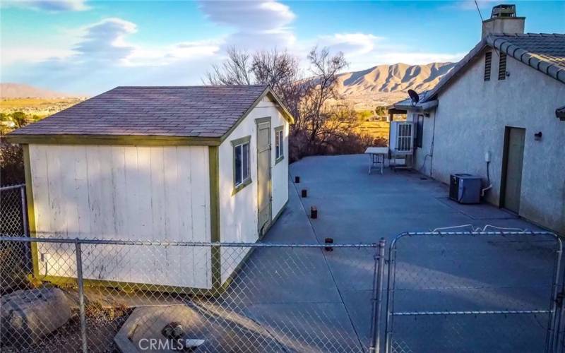 RV parking area with shed and double gate entry.