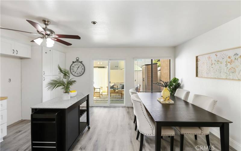 The spacious kitchen and dining area seamlessly flow into the outdoor patio.