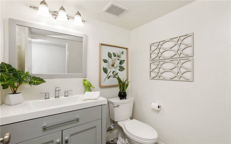 A beautifully remodeled downstairs half bathroom provides convenience for both homeowners and their guests.