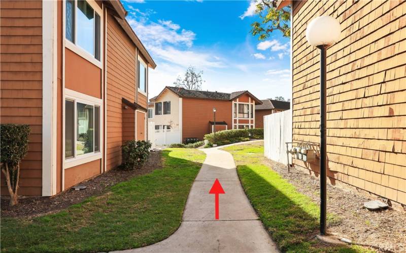 Walk down the pathway to the right of unit #309.