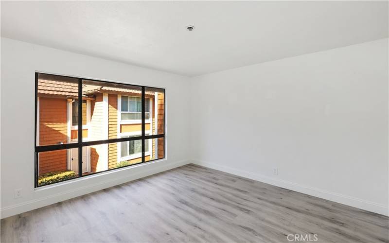 The large window allows plenty of natural light in this secondary room.